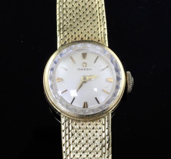 A ladys 18ct gold Omega manual wind wrist watch, on integral 18ct gold Omega bracelet.
